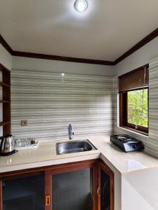 a kitchen with a sink and a window at Sembalun agro villa&restoran in Sembalun Lawang