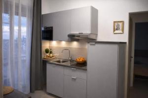 a kitchen with a sink and a counter top at Suite Panoramica - Novara Centro in Novara