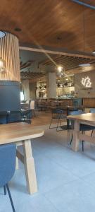 a room with tables and chairs in a building at Apartement LUNA Hotel Zlatni javor in Jahorina +9 photos