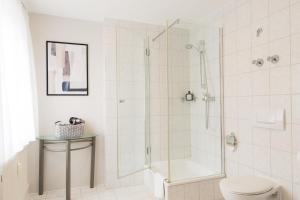 a bathroom with a shower and a toilet at Hotel Garni Promenade in Weißenhorn +45 photos