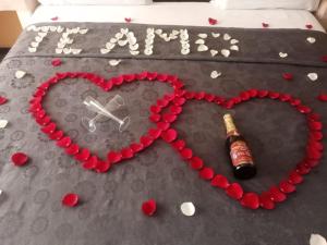 a bottle of champagne and a heart on a bed at Hotel Florencia in Mexico City