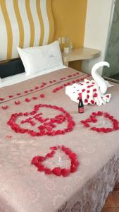 a bed with a bunch of red roses on it at Hotel Florencia in Mexico City