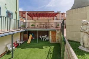 a yard with a statue and a playground at Casa Rural Casa Clemen in Villalba Baja