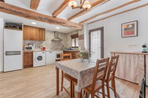 a kitchen with a table and chairs in a room at Casa Rural Casa Clemen in Villalba Baja