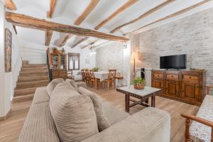 a living room with a couch and a table at Casa Rural Casa Clemen in Villalba Baja