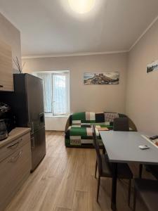 a living room with a bed and a kitchen with a table at Panoramic Apartment 5Terre La Spezia in La Spezia
