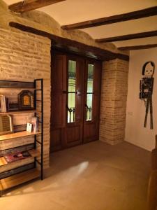 a room with a wooden door and a brick wall at Valencia Catedral Apt in Valencia +10 photos