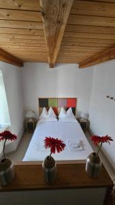 a bedroom with a bed with red flowers on it at TorreCielo in Foligno