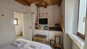 a bedroom with a bed and a tv on the wall at TorreCielo in Foligno