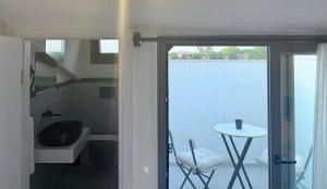 a bathroom with a view of the water and a table at Arıcan Pansiyon in Fethiye