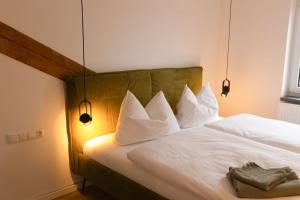 a bedroom with a bed with white pillows at Appartment 1 Frau Isi in Mellrichstadt