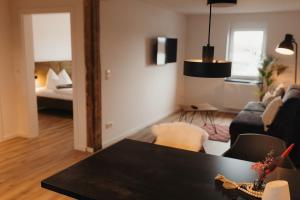 a living room with a table and a couch at Appartment 1 Frau Isi in Mellrichstadt