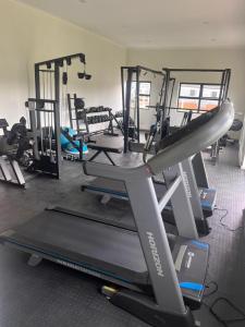 a gym with several tread machines and a treadmill at Royal Golfview Stay in Boksburg