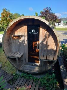 a small wooden dog house sitting on a wooden deck at Reefton in Reefton