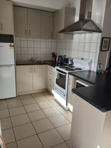 a kitchen with white appliances and a black counter top at Reefton in Reefton +11 photos