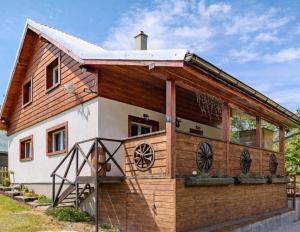 a large wooden house with a large window at Wellness chata Kozička in Klokočov