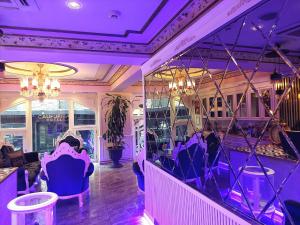 a room with purple lighting and chairs in a restaurant at Leyenda Boutıque Hotel in Istanbul