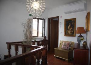 a living room with a chandelier and a stair case at Casa Duas Fontes in Capinha