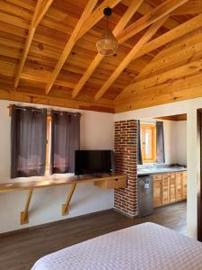 a bedroom with a bed and a wooden ceiling at Cabañas Tlaxomolco in Tepoztlán