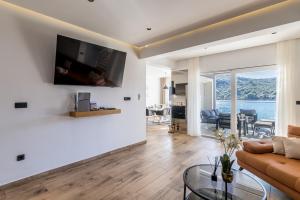 a living room with a couch and a glass table at Beachfront Luxury Villa in Vinišće