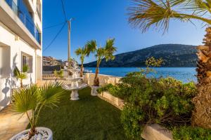 a house with a garden with a view of the water at Beachfront Luxury Villa in Vinišće