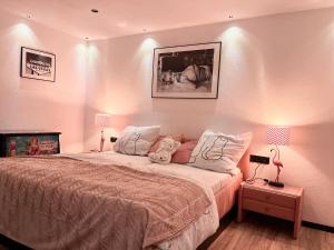 a bedroom with a large bed with two lamps at unique Ferienwohnung in Leutkirch im Allgäu
