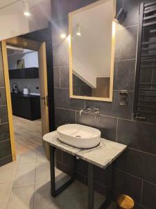 a bathroom with a sink and a mirror at Willa Górska Pasja in Szczyrk