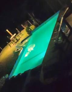 a green surfboard is sitting next to a street at Tierra Nuestra in Villa Ciudad de América