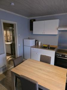 a kitchen with a table and chairs and a counter top at Les deux écureuils in Vresse-sur-Semois
