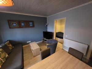 a living room with a couch and a table at Les deux écureuils in Vresse-sur-Semois