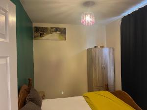 a bedroom with a bed and a chandelier at STOCKTON CONTTRACTOR DIGs in Stockton-on-Tees +5 photos