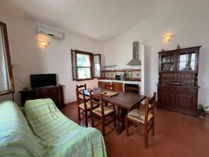 a living room with a table and a couch at Il Lentischio Casa 3 in Nulvi
