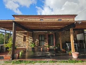 a brick house with a patio with potted plants at podere dell'ovo in Gabbro +16 photos