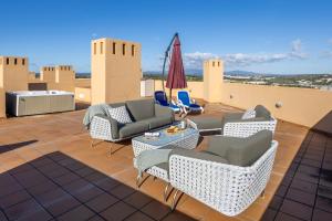 a patio with couches and chairs on a roof at Infinity Penthouse in Lagos