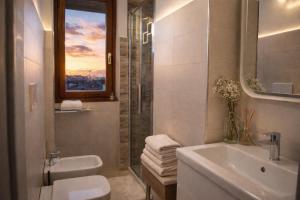 a bathroom with a sink and a toilet and a shower at Suite Panoramica - Novara Centro in Novara