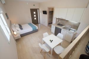 a small apartment with a bed and a table and chairs at Alexandra's Residence in Kefallonia