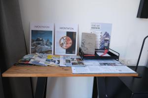 a table with publications and posters on a wall at Alpencabin Montafon in Vandans