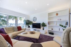 a living room with a couch and a tv at Infinity Penthouse in Lagos