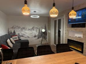 a living room with a couch and a fireplace at loyika , résidence avec caméra et digicode possibilité location voiture Mercedes ,garage ,climatisation ,cheminée, Netflix, petit déjeuner , repas du soir fondue, raclette , barbecue sur demande in Albertville