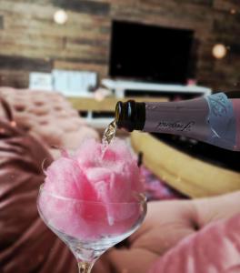 a bottle of wine being poured into a wine glass at Laci Lak Premium apartment in Oradea