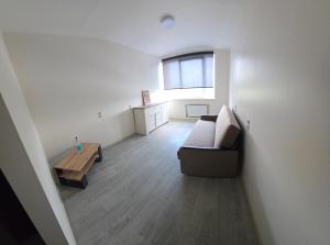 a living room with a couch and a table at Hostel istaba in Rēzekne