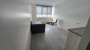 a living room with a couch and a table at Hostel istaba in Rēzekne