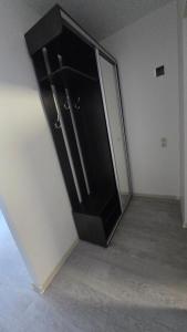 a black cabinet in the corner of a room at Hostel istaba in Rēzekne
