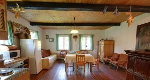 a kitchen and living room with a table and a couch at Chalupa Žernovka in Žernov
