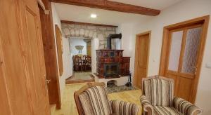 a living room with two chairs and a fireplace at Chalupa Žernovka in Žernov