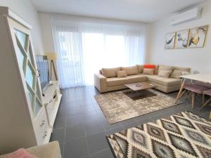 a living room with a couch and a table at Tale Sunset Apartment in Lezhë