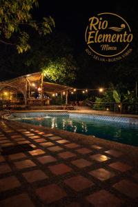 a swimming pool at night with a sign that reads rico elenaulumulum at Rio Elemento Minca in Santa Marta +34 photos