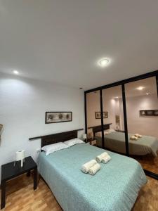 a bedroom with two beds and a large mirror at The Ruzafa by Laura - AVE in Valencia