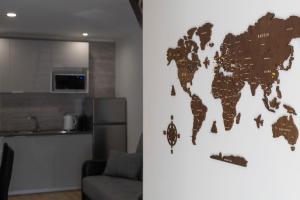 a living room with a map of the world on the wall at Modern Duplex Close to the Beach in Armação de Pêra