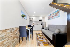 a living room with a couch and a table at Modern Duplex Close to the Beach in Armação de Pêra